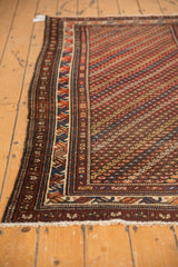 Vintage Kurdish rug's diagonal blossom field, brick red, navy, brown tones, and border.