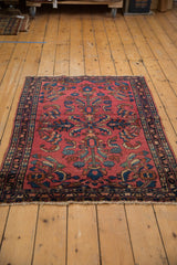 Hand knotted Vintage Lilihan rug with raspberry red field, bursting floral palmettes, and vine borders.