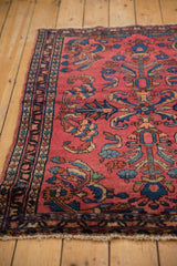 Raspberry red field of vintage Lilihan rug, with bursting floral palmettes and navy border.