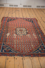 Antique Kurdish Hamadan rug showcasing madder root red boteh field, ivory medallion, and age-consistent foundation wear.