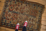 Antique Caucasian rug's paneled design with medallions, brick red, sky blue, beige, and visible foundation.