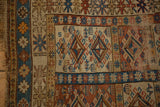 Early 20th century Caucasian rug, worn geometric brick red, sky blue, beige patterns.
