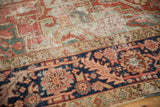 Navy border with cherry red motifs beside a worn powder blue field.