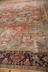 Antique Heriz carpet border, showing navy and cherry patterns, worn rectilinear field, and poly-chrome selvage.