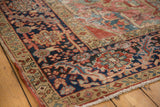 Corner detail of antique Heriz carpet, showing restored poly-chrome selvage and navy floral border.