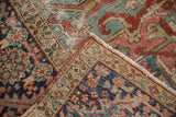 Antique Heriz carpet corner detail with worn pile, poly-chrome selvage, and geometric vine patterns.