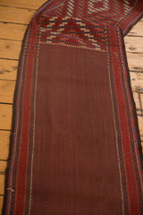 Antique Persian Verneh runner's plain brick red field and geometric woven side border.