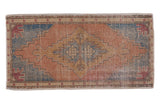 Vintage Distressed Oushak rug, geometric stepped medallion in faded terracotta, blue, and beige tones.