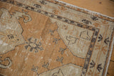 Distressed vintage Oushak rug runner with mostly even wear, copper, ivory, and charcoal patterns.
