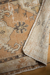 Distressed vintage Oushak rug revealing worn copper pile and hand-knotted woven foundation.