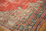Worn cherry red pile and European-inspired corner spandrel on a vintage Oushak rug.