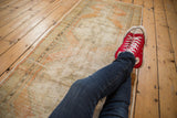 Vintage distressed Oushak runner's pale terra cotta and ivory tones, revealing worn knot heads.
