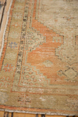 Patinaed pale tangerine and sand tones with geometric border on this Oushak runner.