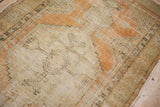 Distressed vintage Oushak rug texture with pale terra cotta and sand germinating motifs.