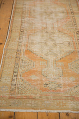 Distressed vintage Oushak runner with muted pale orange and ivory low pile.