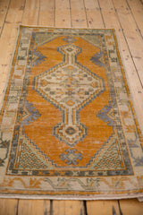 Distressed Oushak rug runner with worn tangerine orange pile and geometric patterns.