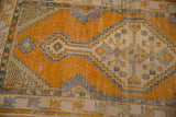 Vivid saffron orange distressed texture with ivory, pale seafoam, and charcoal patterns.