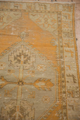 Distressed orange and ivory Oushak runner pile with visible texture and side selvage.