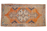 Distressed Oushak runner: tangerine orange field, cream diamond medallion, multi-color geometric borders.
