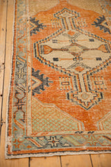 Distressed vintage Oushak runner corner, highlighting germinating plant spandrels in tangerine and seafoam.