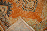 Distressed orange pile and hand-knotted foundation of a vintage Turkish Oushak runner.