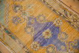 Distressed royal blue diamond medallion and ivory, mint floral motifs on saffron Oushak runner.