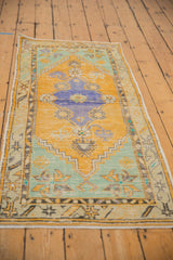 Distressed Oushak runner with worn saffron yellow, mint green, and shadow blue.