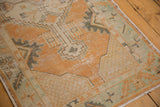Intact side cord selvage, mint green border, and worn tangerine vinery detail.