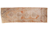 Distressed Oushak runner with scalloped medallion, floral design in blush, terra cotta, ivory.