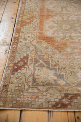 Distressed Oushak runner's barber pole border and muted terra cotta, ivory worn texture.