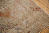 Distressed Oushak rug detail showing low pile texture in blush, terra cotta, and ivory.