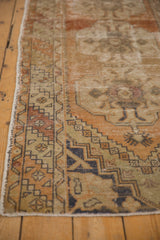 Distressed vintage Oushak runner border detail, terra cotta, ivory, navy geometric pattern, visible wear.