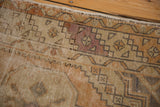 Distressed pile, with mostly even wear, highlighting barber pole border and dusty blush field tones.