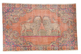 Vintage Distressed Oushak rug, pictorial lions on terracotta, rose, and denim blue.