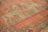 Distressed pictorial lion motif on vintage Oushak rug, tan, olive, rose, and pink.