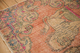 Worn texture of a vintage distressed Oushak rug in rose, blush, and denim blue.