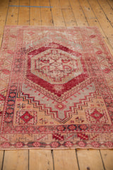 Distressed cherry red main border with stepped patterns on a vintage Oushak rug.