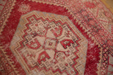 Distressed Vintage Oushak rug texture, displaying mostly even wear, cherry red, and beige motifs.