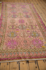 Distressed vintage Oushak runner: detailed floral gul pattern, dusty rose, mint, purple, even wear.