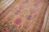 Distressed vintage Oushak runner showing floral gul motifs and even wear with vibrant colors.