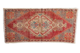 Vintage Distressed Oushak rug runner with oversize stepped medallion in red, beige, and silver.
