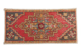 Distressed vintage Oushak rug mat, cherry red medallion, muted floral details. 1'7
