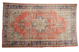 Distressed vintage Oushak rug, brick red and royal blue, with Rococo stylized medallion. 5'9