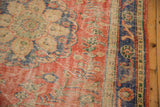 Faded brick red and royal blue Oushak rug with mostly even pile wear.