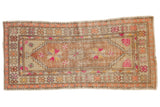 Vintage distressed Oushak runner with central dusty copper design and colorful pinwheel motifs, 2'5