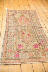 Original side selvages and worn pinwheel motifs on a vintage distressed Oushak runner.