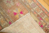 Distressed Oushak rug pile with even wear to knot heads and hand-knotted foundation.