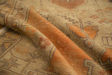 Textured distressed Oushak rug runner with tangerine orange, sand, and geometric vinery motifs.