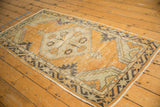 Vintage distressed Oushak rug with dusty gold, antique ivory, and charcoal patterns. Visible wear to knot heads.