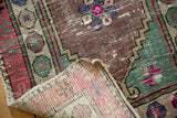 Distressed Oushak rug showing abrash, foundation wear, and its unique woven reverse.
